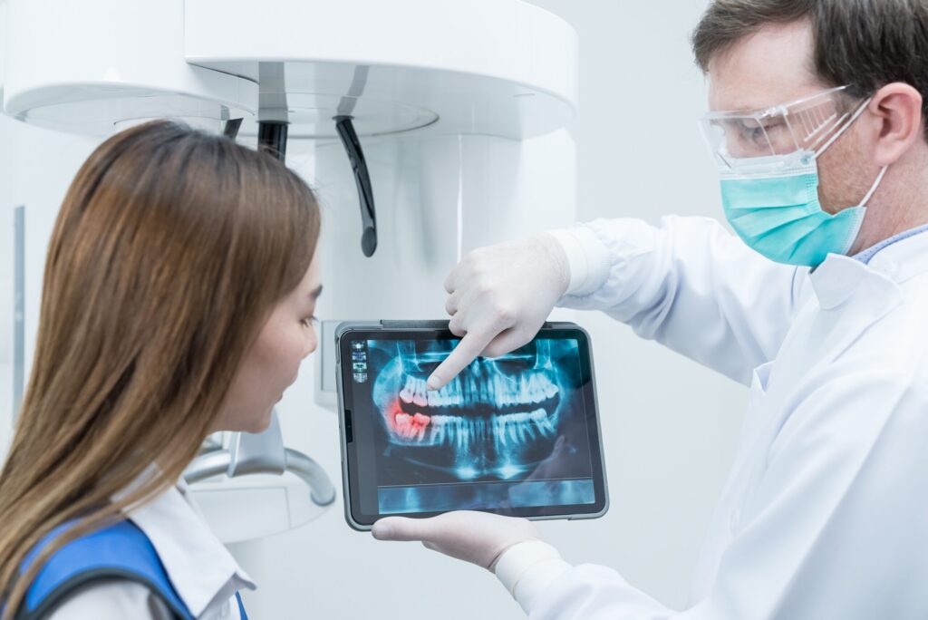 Caucasian,Male,Dentist,Hold,Digital,Tablet,And,Explaining,Tooth,Problem.